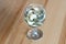 Wine glass on table coins  money spent on alcohol closeup