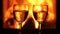 Wine glasses in front of fireplace - hands clinking