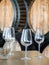 Wine glasses in front of wooden wine barrels