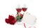 Wine in glasses, red roses, ribbon and empty card for a message