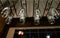 Wine glasses stacked on black metal hanging bar glass racks in a bar
