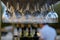 Wine glasses stacked on black metal hanging bar glass racks in a bar