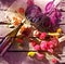 Wine, grapes and flowers on grungy wooden table.