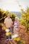 Wine and grapes. Harvesting grapes. Smiling couple in vineyard celebrating harvesting grapes