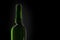 Wine green bottle silhouette. Closeup of an opening of a wine bottle with cork in front of black background with text field. There