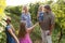 Wine grower family in vineyard before harvesting