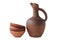 A wine jug and set of clay terracotta cups