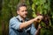 wine maker cutting grapevine with garden scissors, winery