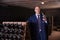 Wine producer inspecting quality of red wine in winery vault