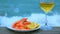 Wine and shrimp on a background of storm surf wave