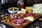 Wine snack. Prosciutto, Parma ham, salami, almonds, olives, baguette, blue cheese, parmesan. Antipasti