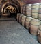 Wine storage cove with a stacked  row of wooden barrels