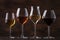 Wine tasting concept, still and sparkling wines. Red, white wine, rose and champagne in wine glasses on vintage wooden table