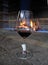 Wine tasting glass with red wine against of fire place