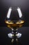 Wineglass of cognac on a gray gradient background