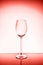 WIneglass on the light background . Living coral theme - color of the year 2019