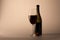 Wineglass red wine black bottle