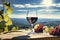 Wineglass with red wine and grapes on a background of green field and blue sky