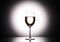 Wineglass with white wine - transperent liquid - on studio background.