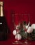 Wineglasses and bottle on red christmas background.