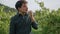 Winegrower eating ripe grapes at plantation close up. Young man tasting harvest.