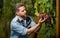 winegrower with ripe grapevine checking harvest, organic