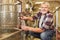 Winemaker checks fresh wine on the fermentation tank