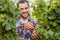 Winemaker harvesting ripe grapes