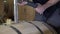 Winemaker Making Wine in Barrel Cellar