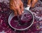 Winemaker`s hand with a glass mug, picking up juice from grape must. Wine material, stum, maun.