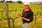 Winemaker standing in his vineyard near Montalcino, Val d`Orcia,