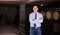 Winemaker standing in wine cellar