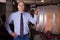 Winemaker standing in wine cellar