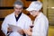 Winemaker team checking and examining producing wine at winery in factory, inspector checking quality and fermenting wine storage.