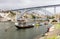 Winery boats moored under Luis I Bridge at Douro river in Porto,