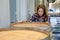 Winery worker woman stand near wine fermentation tank and check the product in modern factory