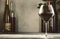 Wines assortment. Red wine in wineglasse and bottles on gray background. Wine bar, shop, tasting concept