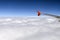 The wing of the Airbus above the clouds in the sky.