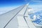 Wing of an airplane flying above the clouds. people looks at the sky from the window of the plane, using air transport to travel