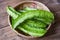 Wing bean on basket and wooden table background, young winged beans vegetable