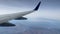 Wing of a commercial airplane flying over and descending in Cabo San Lucas in the state of Baja California Sur, Mexico. Airplane