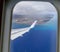 Wing of Hawaiian Airlines plane flying in the air above Honolulu