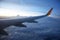 Wing passenger aircraft in flight over the evening clouds