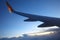 Wing passenger aircraft in flight over the evening clouds