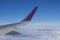 The wing of the plane in the clouds