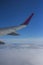 The wing of the plane in the clouds