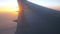 Wing of plane flying above the clouds with sun light. Aircraft flight at sky. Concept of traveling by air. Trip by