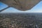 Wing of plane over Melbourne city, Australia