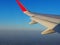 The wing of the plane seen from the window Clear sky