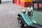 Wing, wheel and headlight of a 1932 vintage car parked in Fortaleza de Sao Tiago in Funchal.